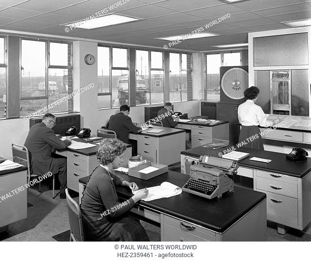 Weighbridge office scene, Spillers foods, Gainsborough, Lincolnshire, 1961. In this photograph, a lorry driver reports to the enquiries window whilst his lorry...
