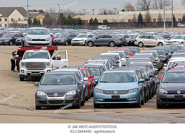 Pontiac, Michigan - A worker unloads some of the thousands of Volkswagen diesel vehicles that are parked at the vacant Pontiac Silverdome