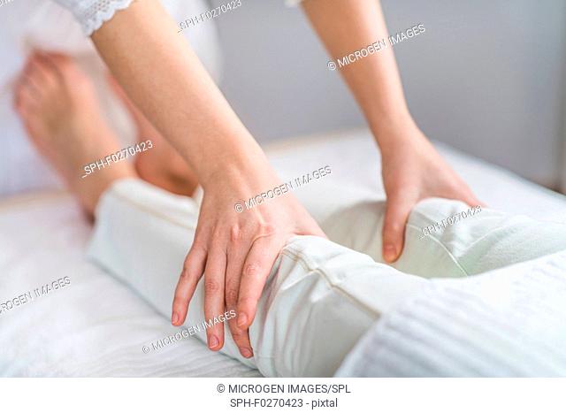 Marma knee therapy. Close-up of Ayurveda practitioner's hands treating left and right patient Janu Marmas. Acupressure points for knee pain