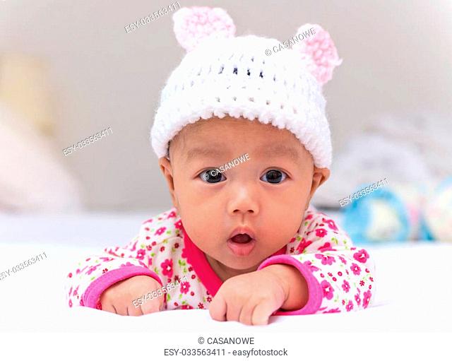 Portrait of cute newborn baby girl on the bed