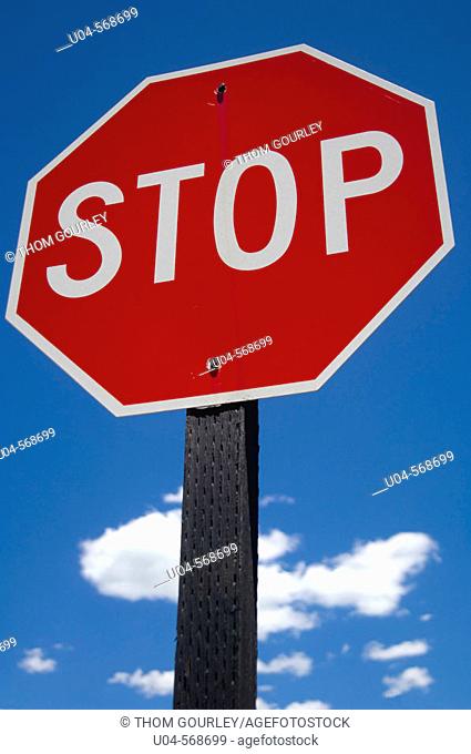 Stop sign against summer sky