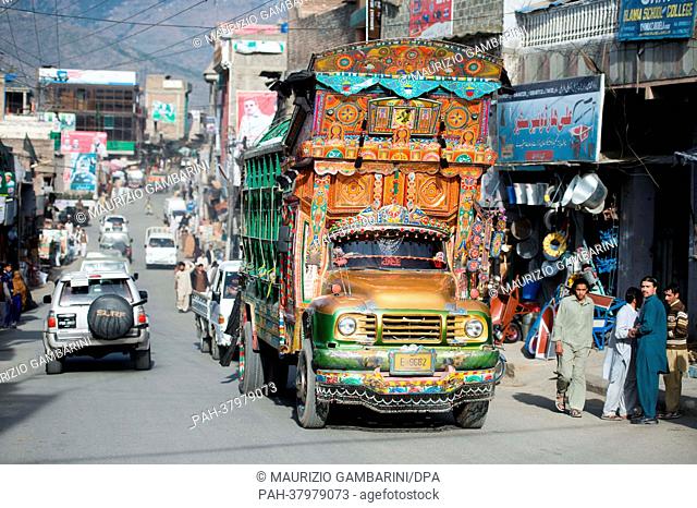 A heavily loaded, regionally typical, colorfully painted truck drives through Khwaza Khela in the Swat valley, Pakistan, 07 March 2013