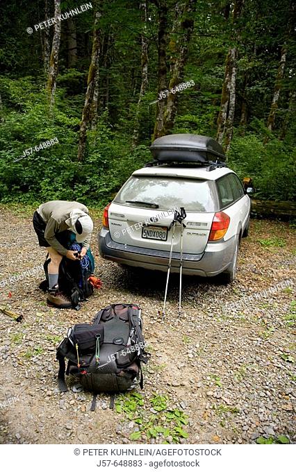 Hiking and climbing in Glacier Peak Wilderness. Washington USA. Packing up at the trailhead for a five day climb in the wilderness