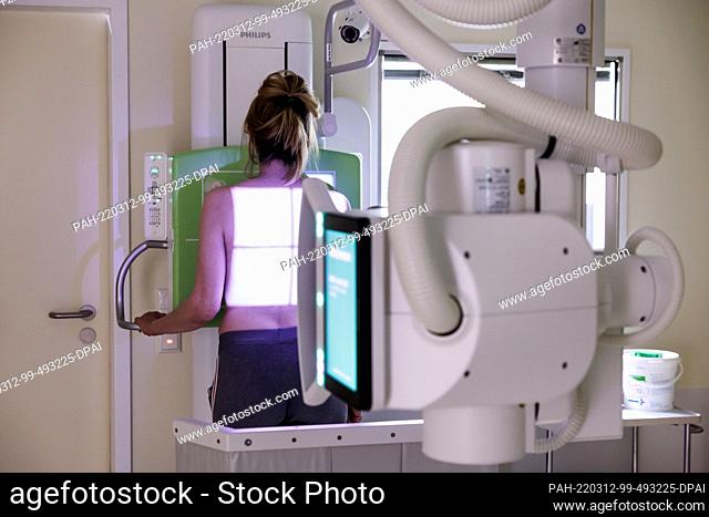 12 March 2022, Bavaria, Gauting: A woman who fled from Ukraine is about to have an X-ray of her lungs taken at the Gauting Lung Clinic
