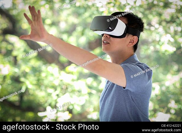 Man gesturing, using VR headset