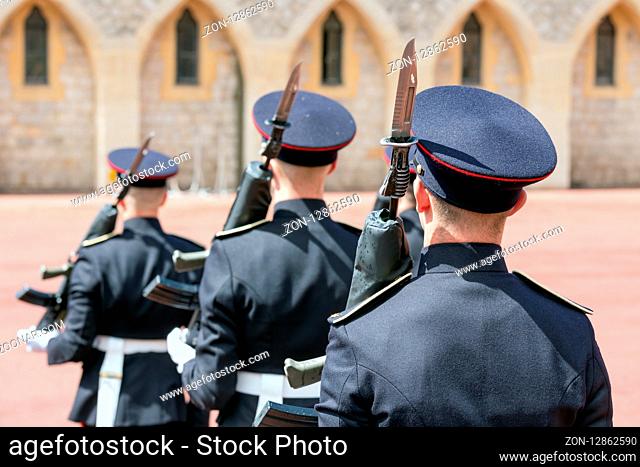 WINDSOR, ENGLAND - JUNE 09, 2017: Changing guard ceremony with soldiers armed with rifles and bayonet in Windsor Castle, country house queen of England