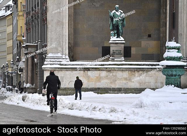 Theme picture winter in the coronavirus pandemic. Hard lockdown. Cyclists and passers-by on the Odeonsplatz in front of the Feldherrnhalle in Munich on January...