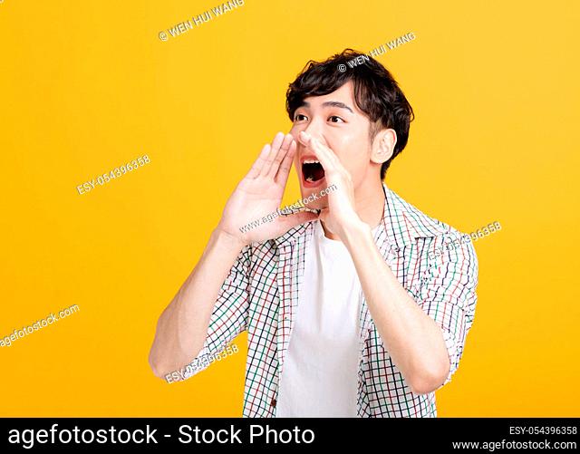 side view of excited young man screaming loudly