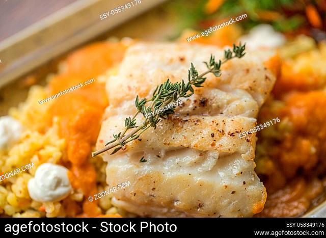 Fish in batter with fresh farm vegetables. fillet of tilapia fish in batter. Baked fish garnished with potatoes and vegetables