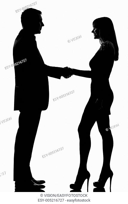 one caucasian couple man and woman handshake in studio silhouette isolated on white background
