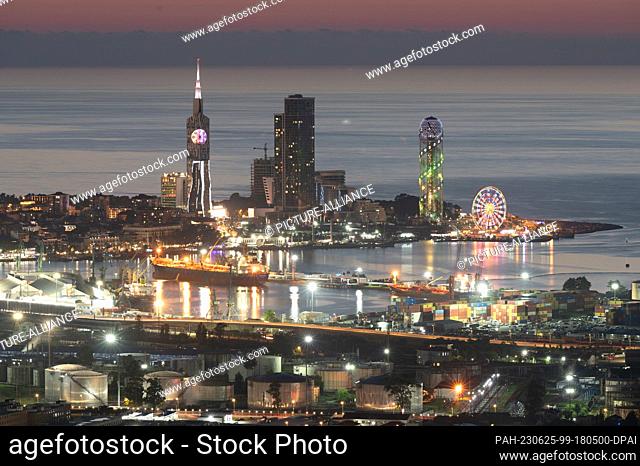24 June 2023, Georgia, Batumi: Brightly lit is the backdrop of the port city on the Black Sea. Photo: Sebastian Kahnert/dpa. - Batumi/Ajaria/Georgia