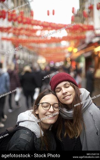 two women enjoying inner world together in China Town in London, Great Britain