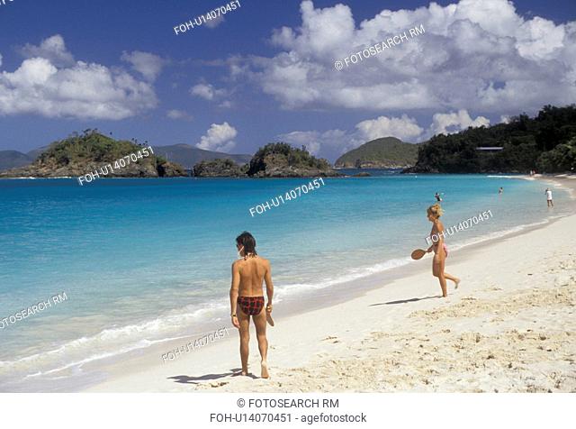 U.S. Virgin Islands, beach, St. John, Caribbean, Virgin Islands, USVI, U.S.V.I Couple playing paddle ball on Trunk Bay Beach at Virgin Islands National Park on...