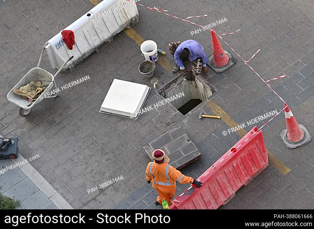 Sewer workers, construction workers, labourers, guest workers , construction site. civil engineering.paving stones. Soccer World Cup 2022 in Qatar from 20
