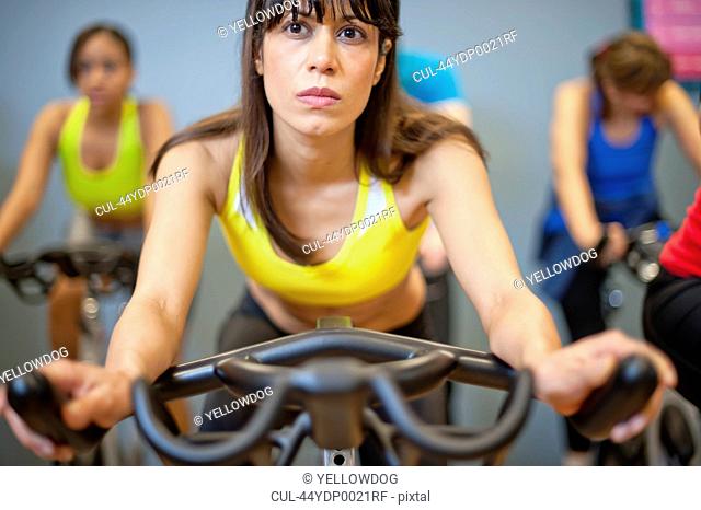 People using spin machines in gym