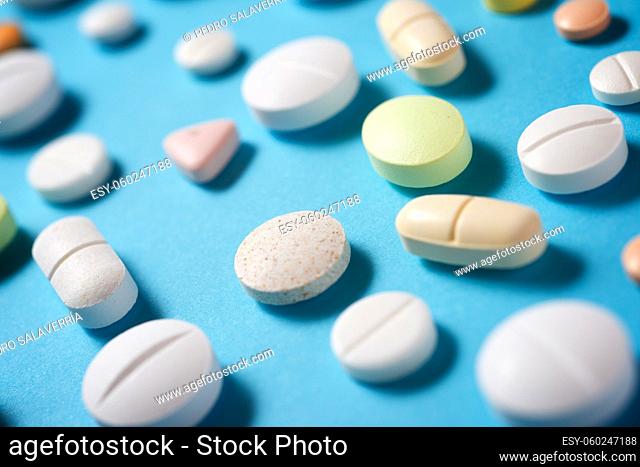 Pills on a blue table