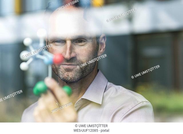 Portrait of scientist with atomic model