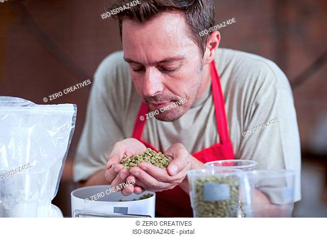 Man smelling handful of grains