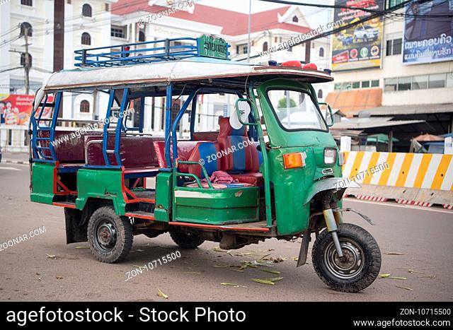a tuck tuck Taxi in the city of vientiane in Laos in the southeastasia