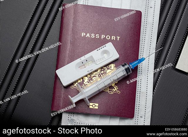 COVID-19, travel and lockdown concept, Passport with Covid-19 rapid test and syringe for vaccination Coronavirus. Traveling requirement flying holiday