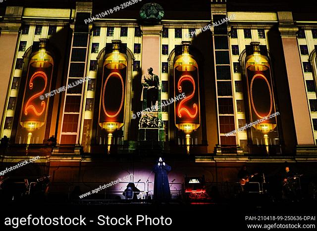 14 April 2021, Rhineland-Palatinate, Worms: Actor Isaak Dentler stands on stage in front of a light projection at the Dreifaltigkeitskirche during a media...