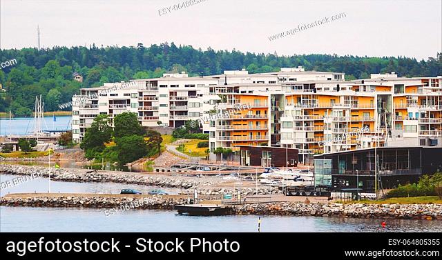 Sweden. Cityscape Panoramic View On Red Swedish Suburb With Multi-storey Houses On Rocky Island Coast In Summer Sunny Evening