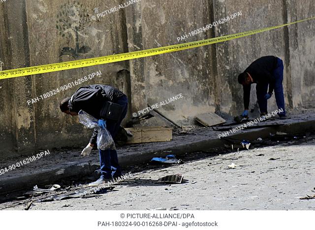dpatop - An Egyptian forensics team and security forces check the location of an explosive placed under a car parked, which hit a convoy of the city's security...