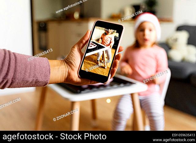 Mother taking photo of child at home. Modern motherhood. High quality photo