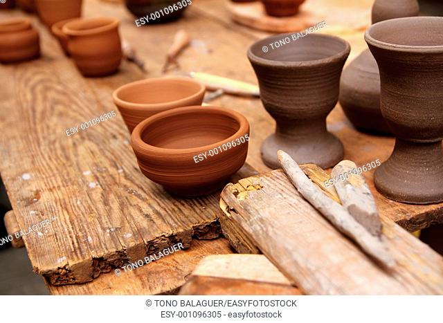 clay pottery potter ceramics handcrafts on vintage table artisan studio
