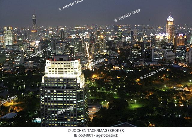 THA Thailand Bangkok Skyline at dusk of Sathorn and Bangrak area view down to Chao Phraya river area