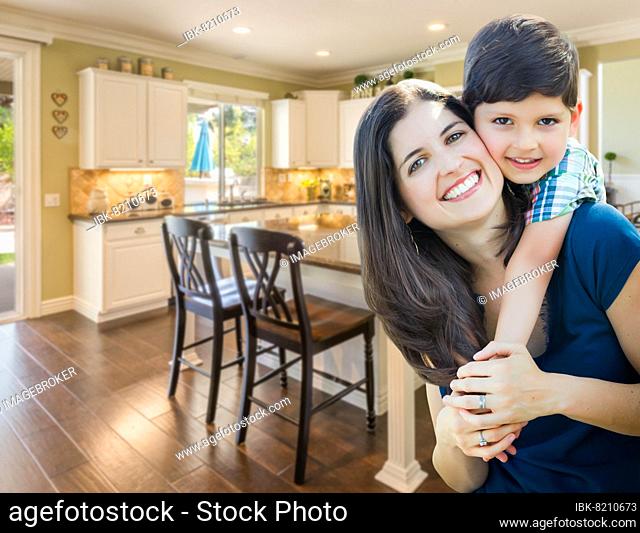 Young mother and son inside beautiful custom kitchen