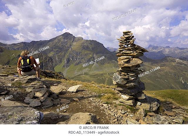Hiker resting at summit of mountain Versettla Montafon Vorarlberg Austria