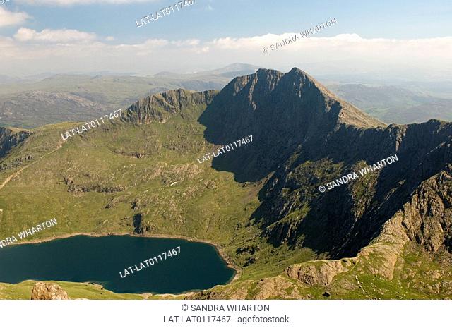 Snowdonia National Park covers 823 square miles of the most beautiful and unspoilt countryside in North Wales. Horseshoe ridge. Lake. paths