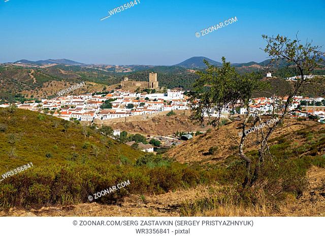 Mertola with the old medieval castle on the hill as viewed from the high opposite side of the Guadiana river. Portugal