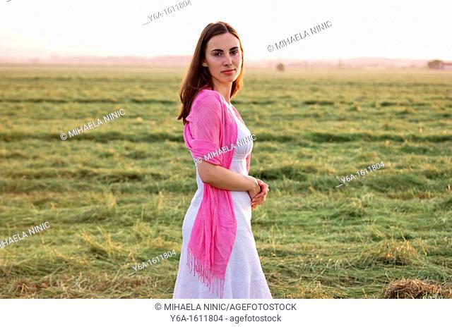 Portrait of a beautiful young woman standing in field