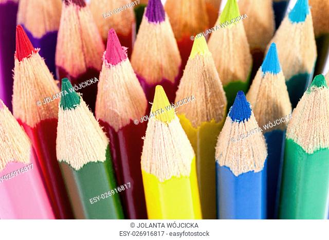 Background of chipped colored crayons on white background, close up
