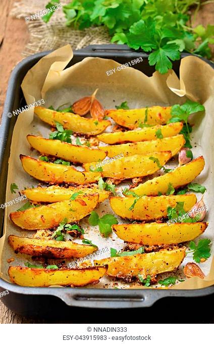 Fried potato wedges with spices and herbs