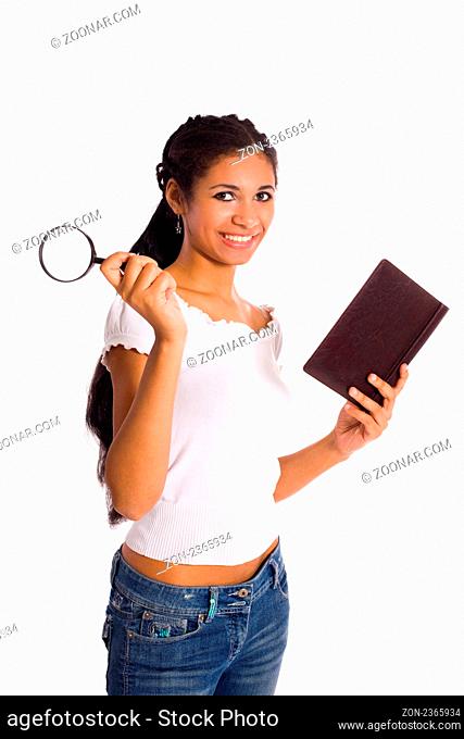 Young mulatto woman holding book and magnifier isolated on white