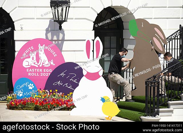 Decorations depicting Easter bunnies and chicks wearing face masks are seen at the South Portico steps of the White House before US President Joe Biden (not...