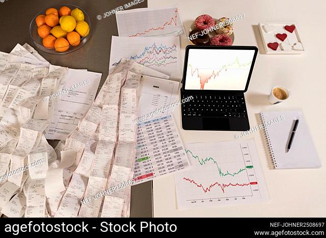Laptop and receipts on table