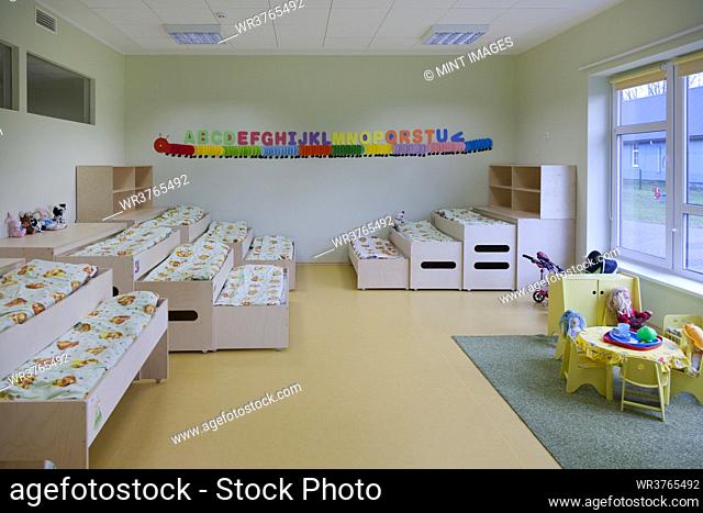 Modern day care nursery or pre-school kindergarten school, bedrooms for nap time, pull out bunks
