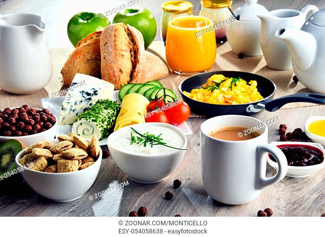 Breakfast served with coffee, orange juice, cheese, cereals and scrambled eggs. Balanced diet