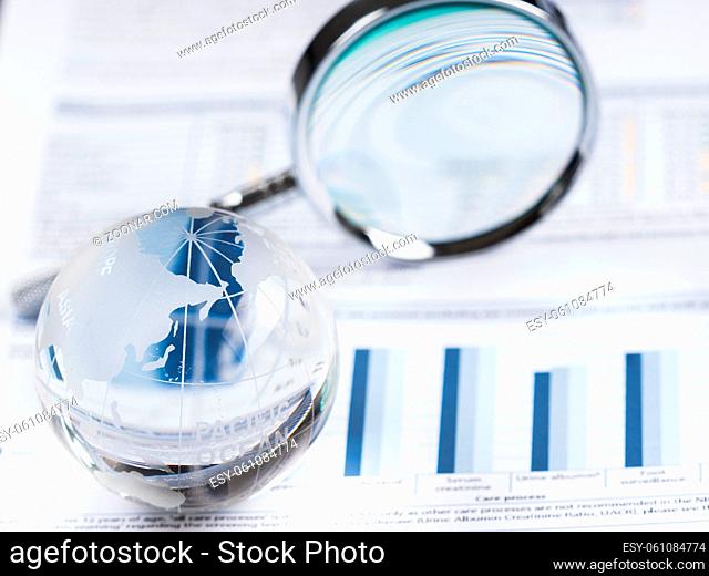 Business Data Analyzing, with magnifying glass and other on the desk