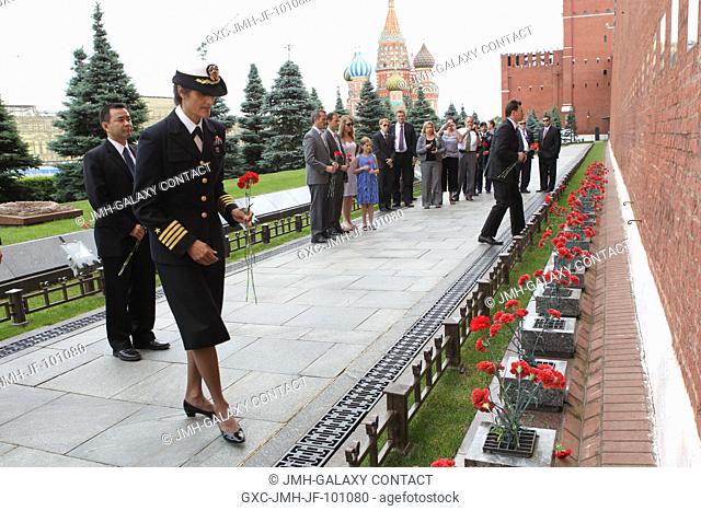 With St. Basil’s Cathedral in the background, Expedition 32/33 Flight Engineer Sunita Williams of NASA prepares to lay flowers at the Kremlin Wall in Red Square...