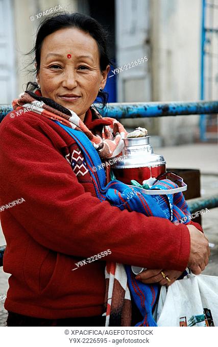 A middle aged woman with sharp eyes selling tea on the top of Tiger Hill in Darjeeling
