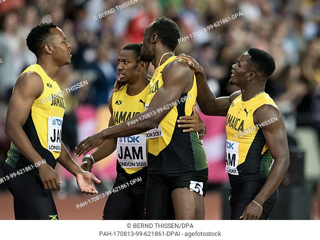 Jamaican athlete Usain Bolt (C) with teammates after suffering an injury while competing in the men's 4 x 100 metre relay race at the IAAF World Championships...