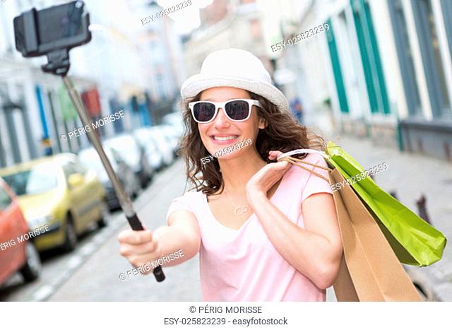 View of a Young attractive woman taking selfie while shopping