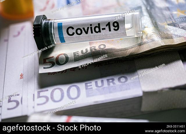 Coronavirus vial on euro banknotes, conceptual image