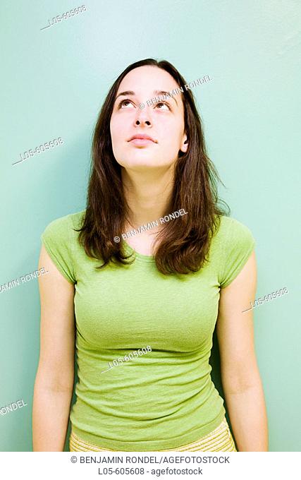 A 24 year old woman looking up