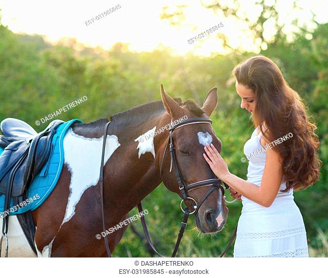 Beautiful woman and a horse. Summer time